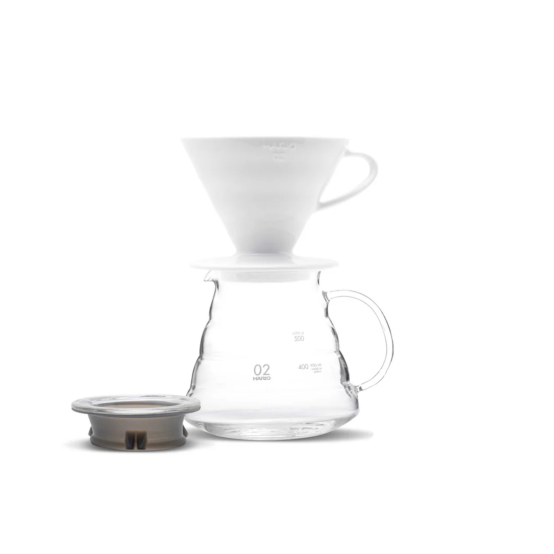 A V60 pour-over setup brewing specialty coffee into a glass server